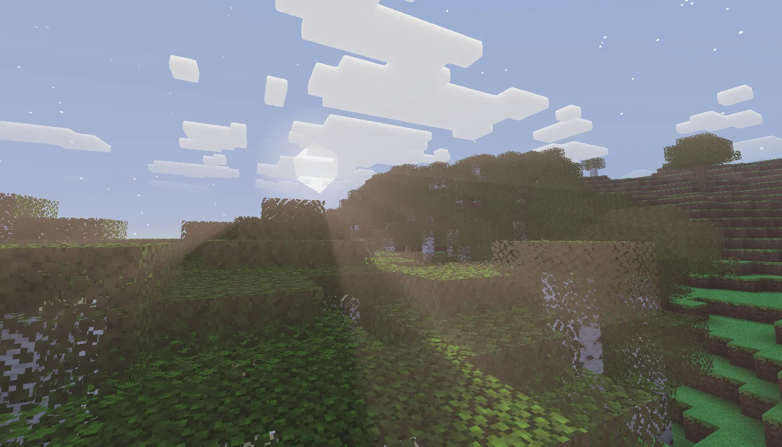 Volumetric light at sunrise viewed from a mountain, showing long light shafts across the terrain